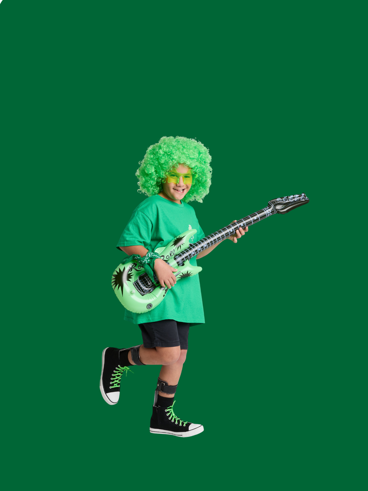 A young boy in viibrant green, the colour celebrating Cerebral Palsy